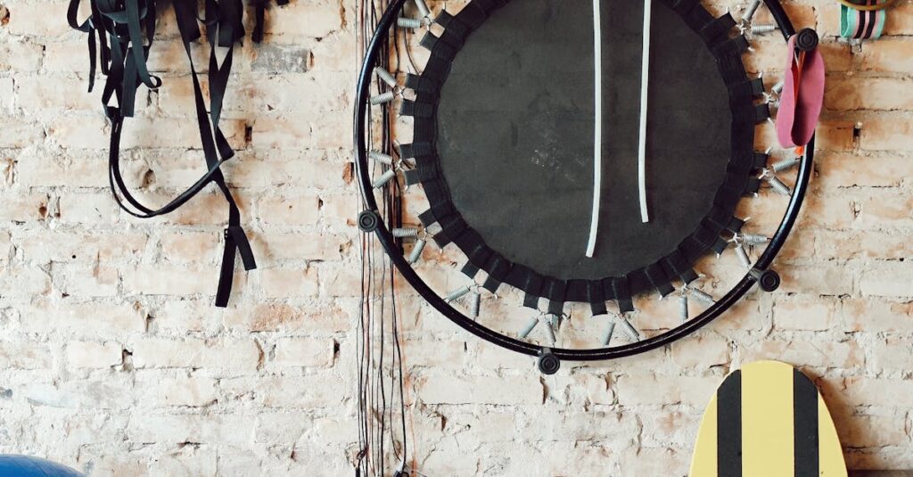 A diverse range of gym equipment arranged neatly against a rustic brick wall in a fitness studio.