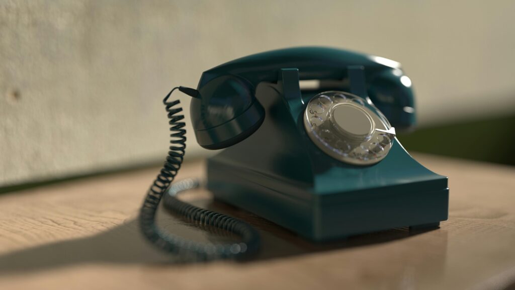 Close-up of a vintage rotary telephone with classic design, evoking nostalgia.
