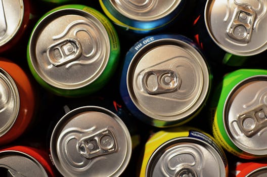 Close-up of colorful beverage cans arranged closely together, showcasing various colors.