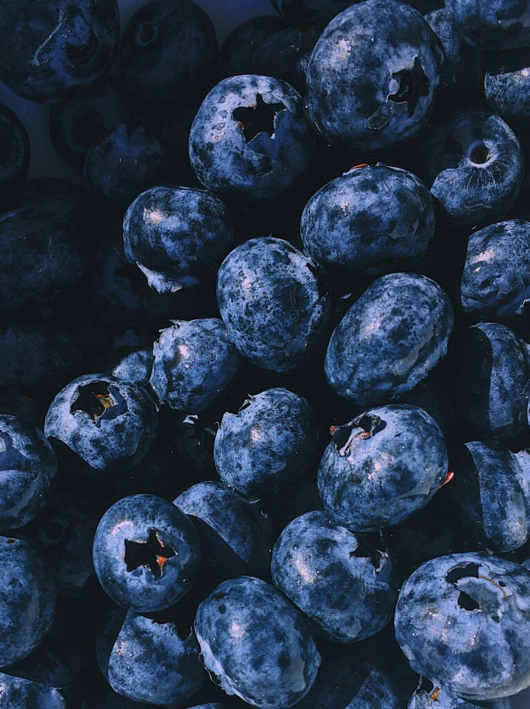 A vibrant close-up of a heap of fresh, juicy blueberries, showcasing their natural beauty and nutritional appeal.
