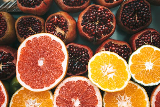 Close-up view of colorful sliced citrus fruits and pomegranates showcasing freshness and nutrition.