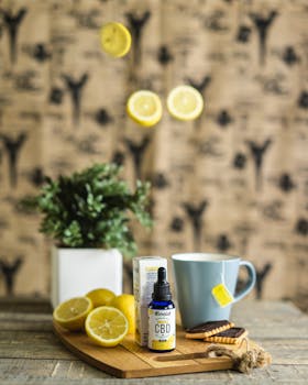 Product photography featuring CBD oil, lemons, tea cup, and rustic background, highlighting a natural and refreshing setup.