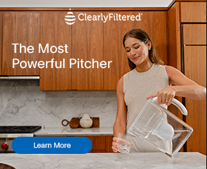 woman pouring filtered water into a glass