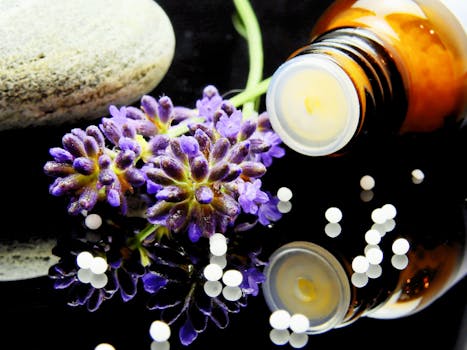 Lavender flowers with herbal homeopathy on a reflective surface, ideal for natural aromatherapy themes for essential oil use.