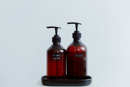 Two elegant brown soap dispensers with text labels on a white background, perfect for lifestyle and product photography.