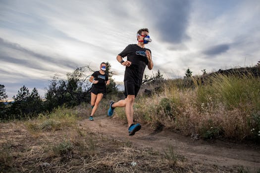 Athletes in VO2 masks running on a trail, showcasing outdoor athletic performance.