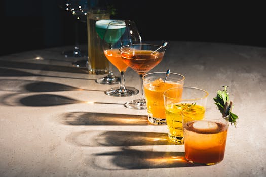 A colorful assortment of cocktails on a bar counter, showcasing diverse drink options.