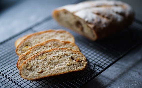 Close-up of fresh homemade nut bread slices on a cooling rack, offering a tasty treat.