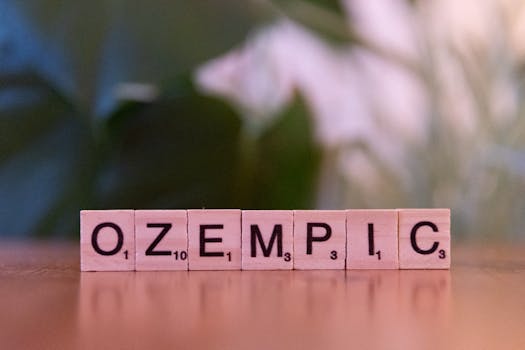 Scrabble tiles spelling 'Ozempic' on a wooden surface, healthcare theme.