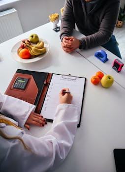 A nutritionist writes a weekly meal plan for a client in an office setting, surrounded by fresh fruits.