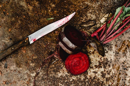 Fresh beetroot slices displayed with a kitchen knife on a rustic surface, showcasing natural textures.