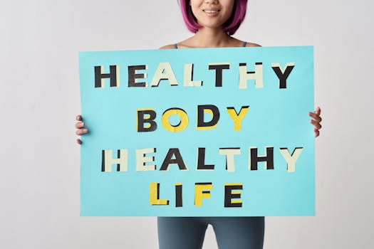 A woman holds a motivational poster advocating a healthy body and life for wellness.