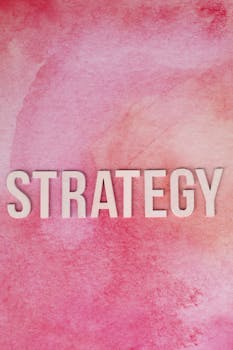 Bold 'Strategy' text on a textured pink background, perfect for business presentations.