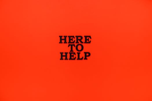 Bold 'Here to Help' motivational quote on a vibrant red background.