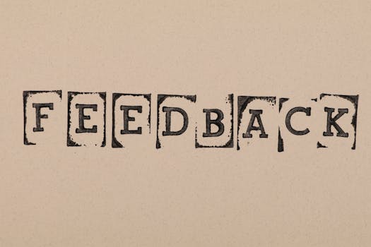 Vintage-style stamped letters spelling 'Feedback' on textured paper background.