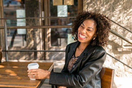 Smiling senior woman relaxing with a coffee at an outdoor cafe, embodying elegant senior style.