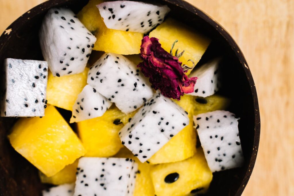 Close-up of a fresh fruit bowl with dragon fruit and pineapple, perfect for healthy eating.